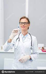 Female doctor with syringe in hand