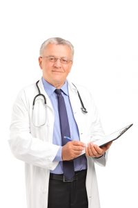 a mature healthcare professional holding a clipboard and posing isolated on white background 1 200x300