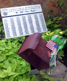 A box beam from the World Trade Center South Tower stands on display in front of the Lewisville Fire Department offices as a memorial to the service members who died as a result of the September 11 attacks