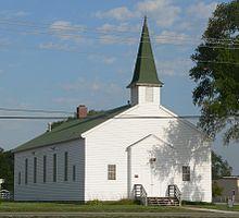 Small wood church with pointed steeple over front door