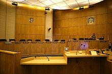 Wood paneling floor to ceiling with seats for 8 members and support staff