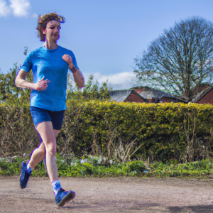 a professional appealing image of a caucasian man or woman jogging on a sunny day